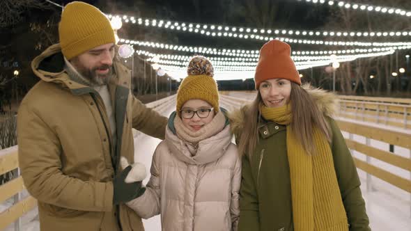 Portrait Of Family On Ice Rink