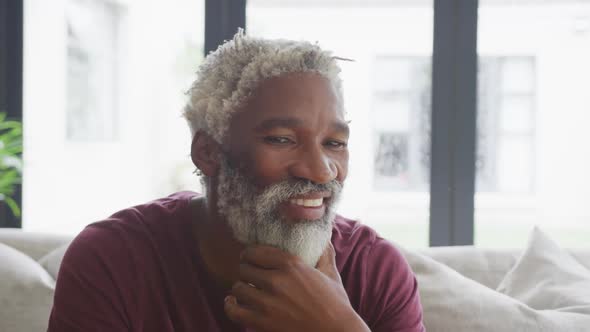 Video of happy african american senior man spending time alone