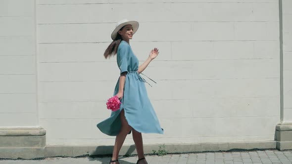 Happy Stylish Charming young mixed race woman Fashion Blogger Walking Along European Urban Street in