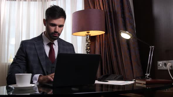 Serious Big Boss Working on Laptop in Office