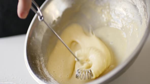 Crop Shot of Woman Preparing Homemade Omelette Mixing with Whisk Eggs.