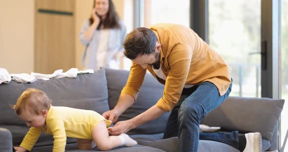 Father Wearing His Little Son at Home