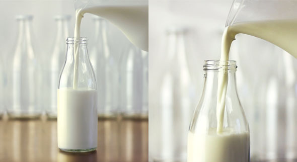 Pouring Milk From a Jug Into a Bottle