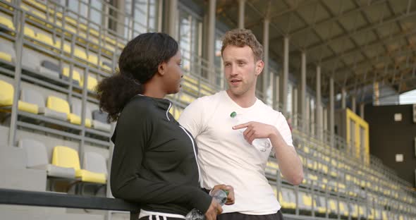 Sport Fitness Couple Relaxing After Training at Stadium