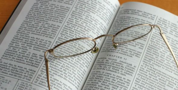 Reading Religious Book with Glasses