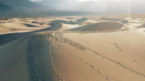 Scenic Nature Aerial Footage Sunset Light Foot Prints on Sand Dunes  Desert