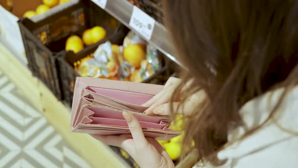 Empty Open Wallet in Female Hands