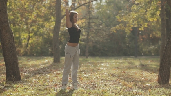 Young Girl Doing a Workout In The Forest