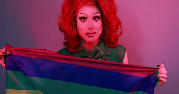 Happy drag queen holding rainbow flag - Lgbt concept
