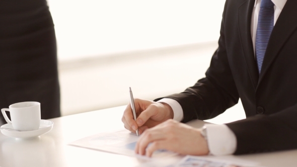 Businessman Hands Signing Papers