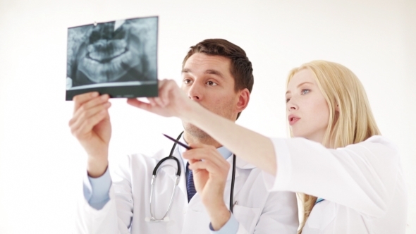 Two Doctors Discussing X-ray Image At Hospital