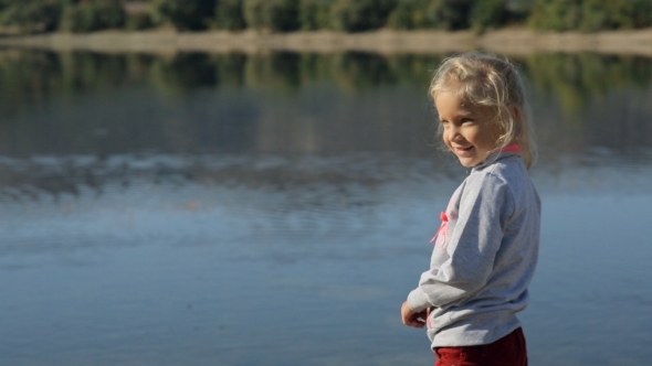 A Wonderful Little Girl Playing Near Pond