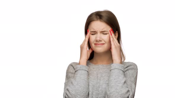 Horizontal Portrait of Tired Woman 20s Feeling Sick Massaging Temples with Fingers and Suffering