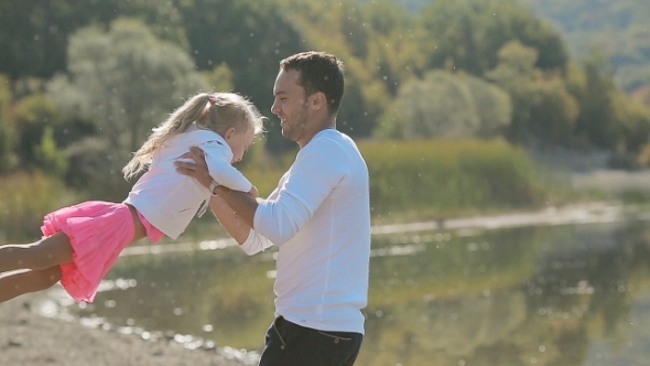 Little Blond Girl Running Toward Father And He
