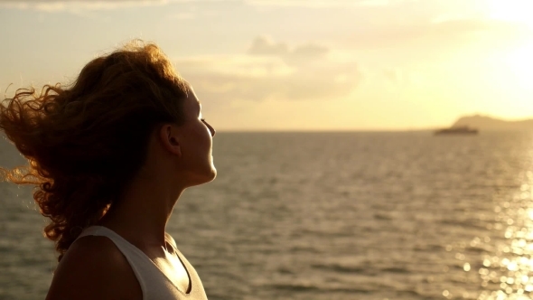 Beautiful Woman In Sunset Light Enjoying The Sea