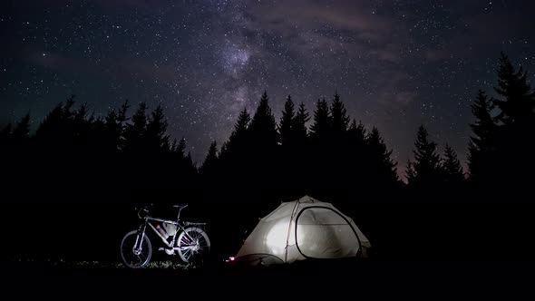 Silhouette of a Man in a Tent at Night