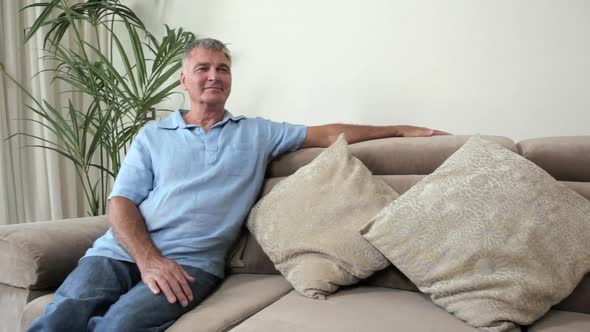 Senior man relaxing on sofa