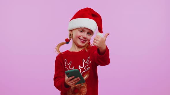Happy Girl in Christmas Deer Sweater Looking Smartphone Display Sincerely Rejoicing Win Success Luck