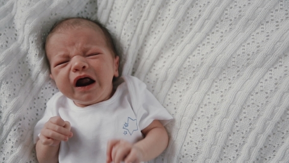 Newborn Baby Crying In Bed