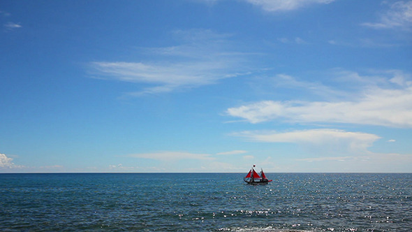 Ship With Red Sails Floating On Sea