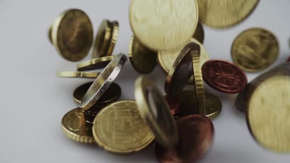 Metal coins falling on table