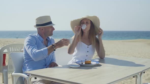 Couple Drinking Coffee and Talking Outdoor