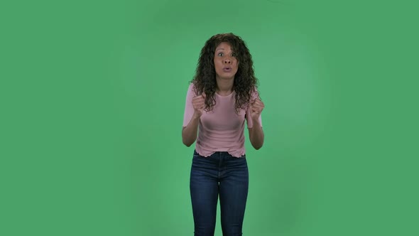 Portrait of Beautiful African American Young Woman Is Looking at the Camera with Excitement, Then