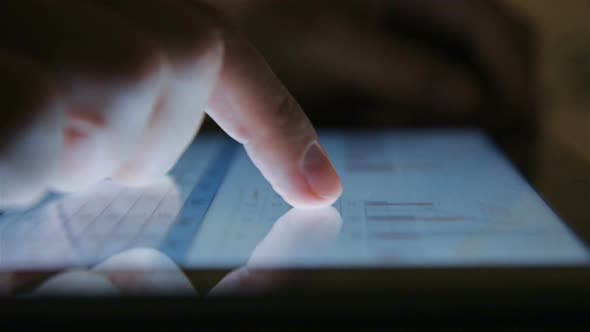 Businessman Using Tablet With Stock Market Report