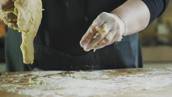 Woman in kitchen kneading dough