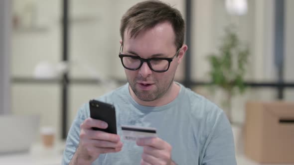 Portrait of Man Excited By Online Shopping Success on Smartphone