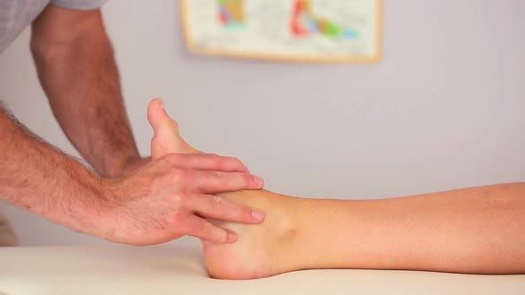Physiotherapist Working On A Patients Foot