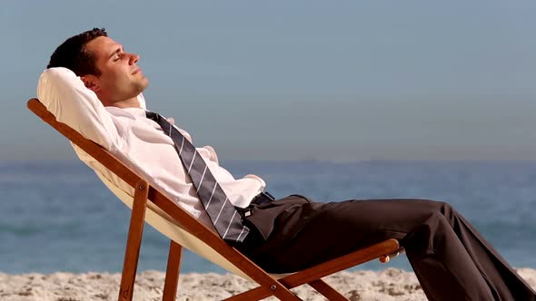 Smiling Businessman Relaxing On The Beach