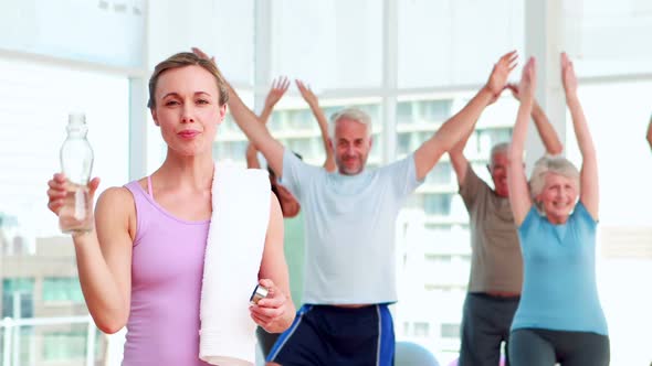 Pilates Instructor Smiling At Camera In Front Of Her Class 2