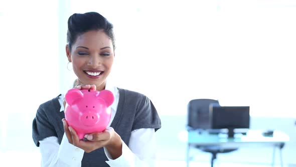 Smiling Businesswoman Checking Piggy Bank