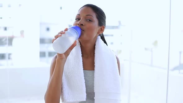 Beautiful Woman With Towel Drinking Water On Her Flask
