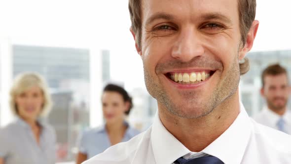 Businessman Smiling In Front Of His Team