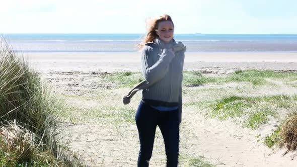 Woman Walking From The Beach