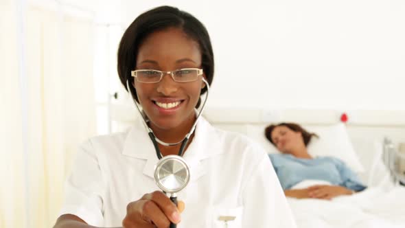 Smiling Nurse In The Ward Holding Her Stethoscope