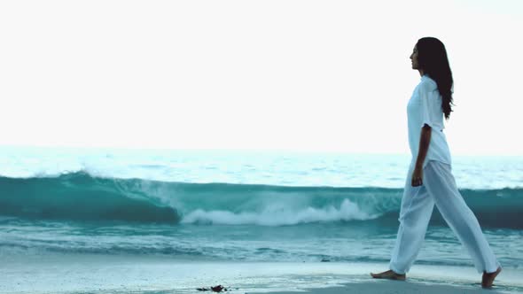 Woman Walking On The Beach