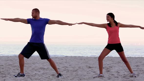 Friends Stretching On The Beach Together