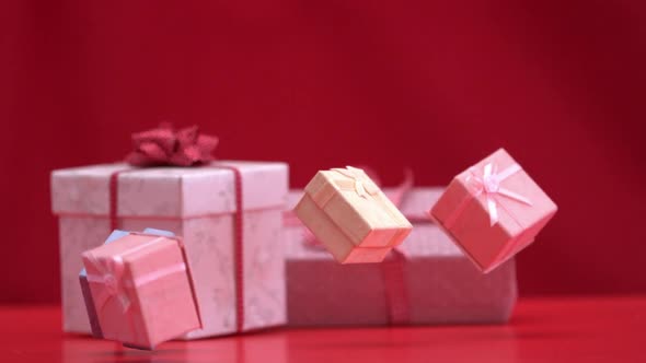 Presents Falling And Bouncing On Red Background