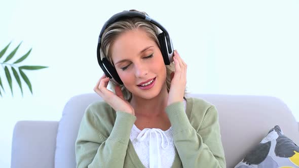 Woman Wearing Headphone And Listening To Music