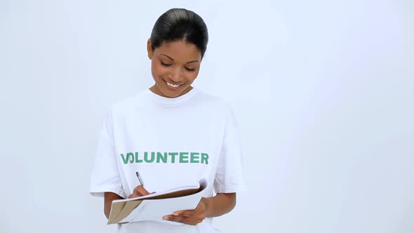 Smiling Volunteer Woman Thinking And Writting On Notebook