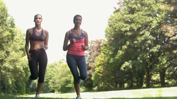 Two Young Girls Jogging In A Park