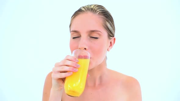 Blond Woman Holding A Glass Of Orange Juice