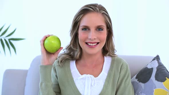 Blond Woman Holding A Green Apple