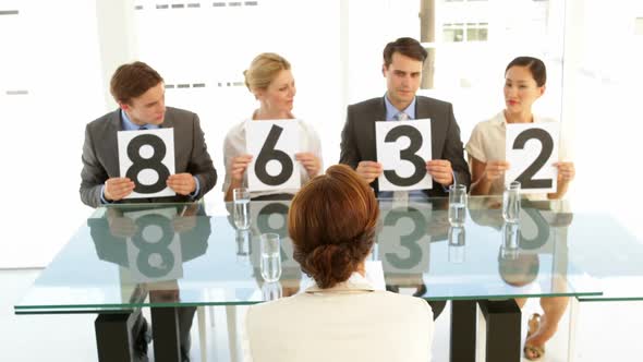 Interview Panel Holding Up Their Marks For The Applicant