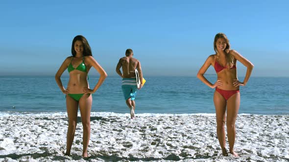 Women Tossing Their Hair While A Friend Is Running Into The Sea