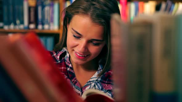 Pretty Student Reading Book Standing In The Library