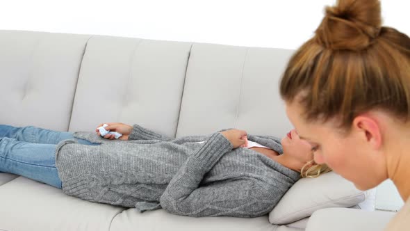 Upset Blonde Woman Lying On Couch Explaining Her Problems